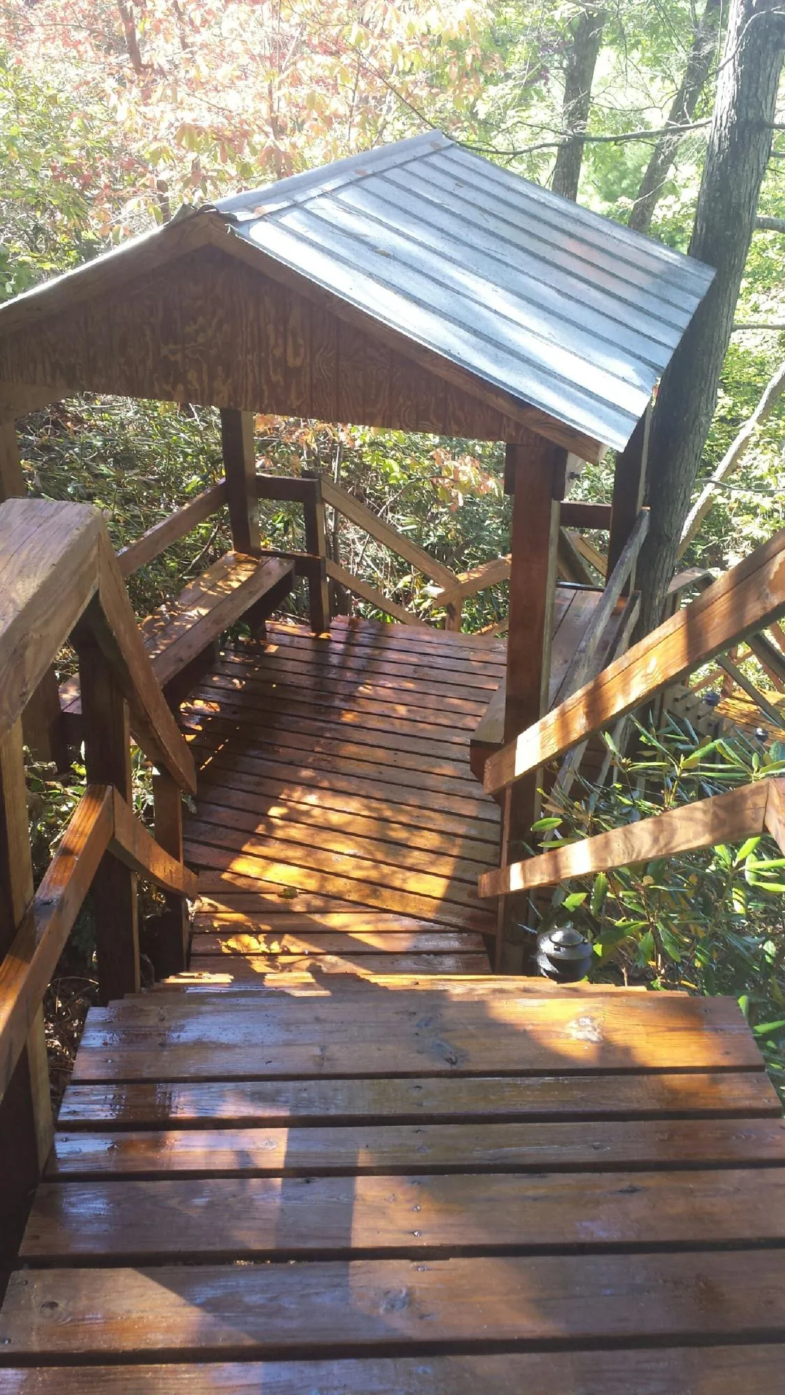 Freshly stained wood walkway and covered shelter with a metal roof in Madison